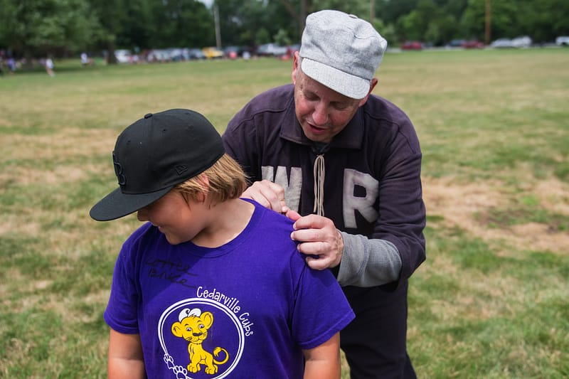A member of the Indianapolis Blues autographs the shirt of a young fan.