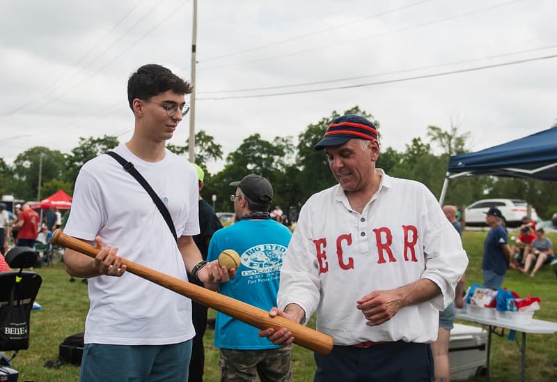 A member of the Elkhart County Railroaders shows off the type of bat that is used in a game played by 1864 rules.